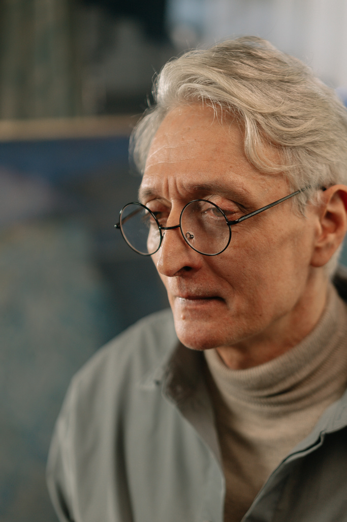 A Close-Up Shot of an Elderly Man Wearing Eyeglasses